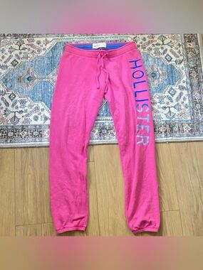 Pink Y2K vintage Hollister sweatpants with blue Hollister text and details